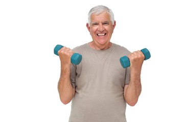 Fototapeta na wymiar Portrait of a happy senior man exercising with dumbbells