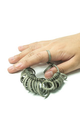 hand with Jeweler finger sizing tools. Ring Gauge , Ring Measure