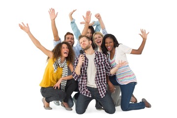 Smiling group of young friends having fun doing karaoke