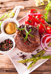 Grilled steaks on wood 