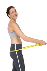 Fototapeta na wymiar Portrait of a fit woman measuring buttocks