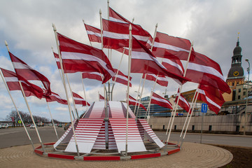 Flags of the Republic of Latvia in a festive decoration.