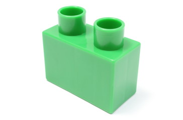 Green building block on white background
