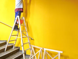 Zelfklevend Fotobehang Leiter mit gelber Wand © grafikplusfoto