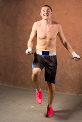 Obraz premium Happy fit young boxer working out