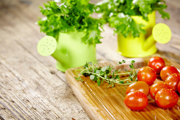 Cherry tomatoes with basil on a wood table