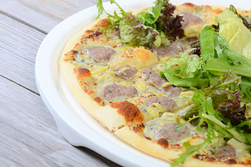 The Italian pizza with house sausage and artichokes