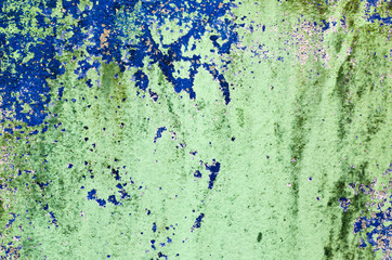 Dirty green paint cement wall closeup