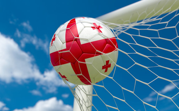 Flag of Georgia and soccer ball in goal net