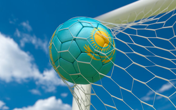 Flag of Kazakhstan and soccer ball in goal net
