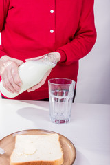 Seniorin mit Milchkanne und Milchglas