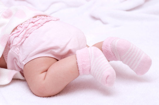 Newborn Baby Girl Feet In Pink Socks