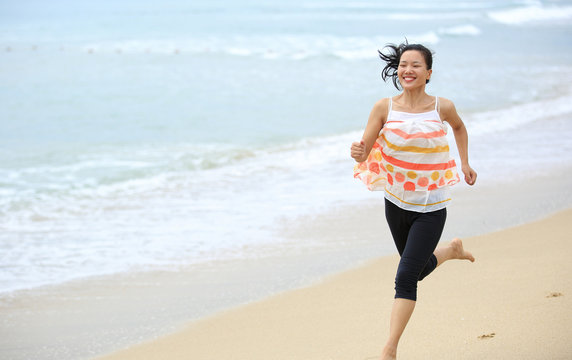 healthy lifestyle woman jogging on seaside beach