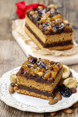 Delicious layer gingerbread cake decorated with dried fruits