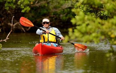 Man paddling in a kayak in Florida