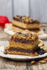 Delicious layer gingerbread cake decorated with dried fruits