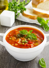 Bowl of minestrone soup with bread