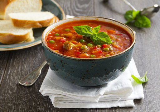 Bowl of minestrone soup with bread