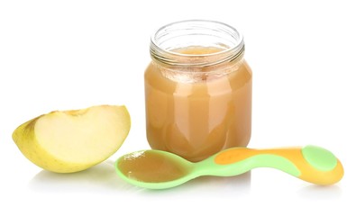 Jar of baby puree with apple and spoon isolated on white