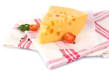 Piece of cheese and tomatoes,on color napkin, isolated on white