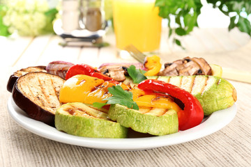 Delicious grilled vegetables on plate on table close-up