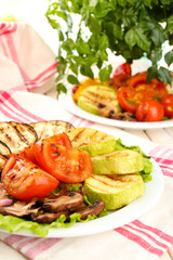 Delicious grilled vegetables on plate on table close-up