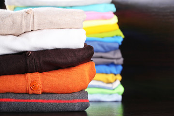 Stack of colorful clothes, on dark background