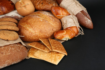 Different types of bread on black background, close-up