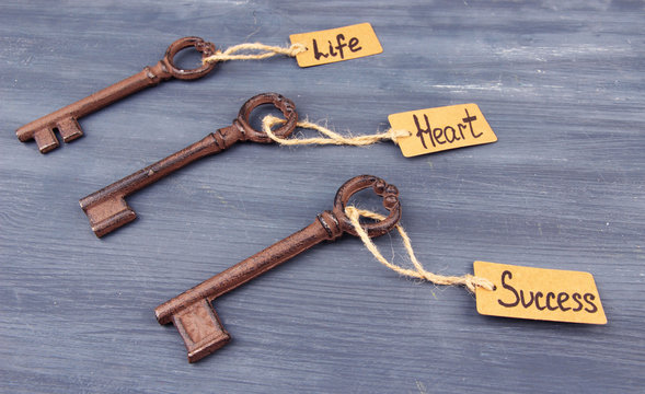 Keys to happiness, Conceptual photo. On color wooden background