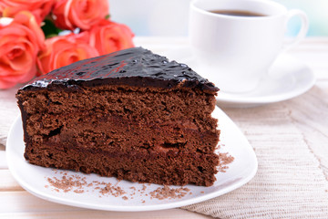 Delicious chocolate cake on plate on table on light background