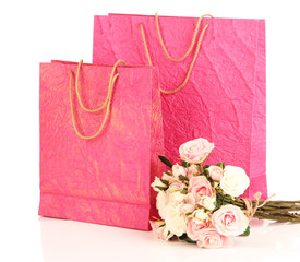 Colorful shopping bags and flowers, isolated on white