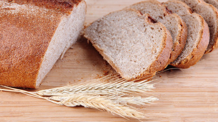 Sliced bread on wooden board close up