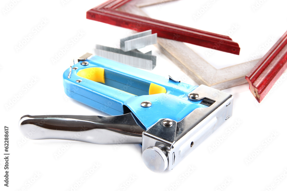 Poster Construction stapler and wooden frames isolated on white