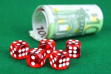 Red dices and money, on green background