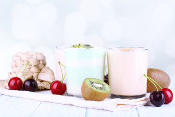 Delicious yogurt with fruits tastes in glasses and fresh fruits