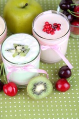 Delicious yogurt with fruits tastes in glasses and fresh fruits
