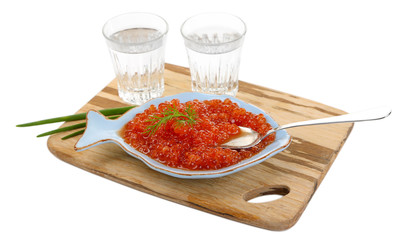 Red caviar in bowl and vodka on wooden board isolated on white