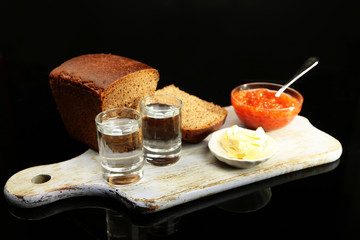 Composition with glasses of vodka, red caviar, fresh bread