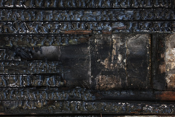 Black burnt wooden wall.  Grunge background.