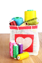 Colorful bobbins of thread  in bag,