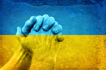Fototapeta premium Hands on Ukrainian Flag