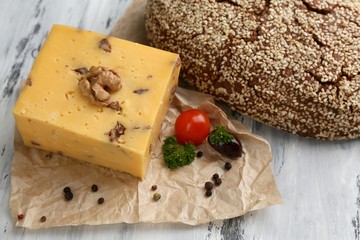 Tasty Italian cheese and bread on wooden table