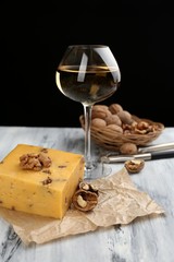 Tasty Italian cheese and glass of vine on wooden table