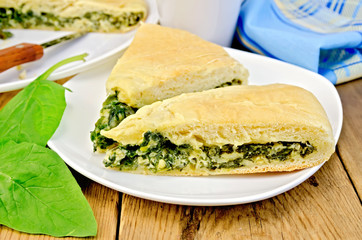 Pie spinach and cheese on board with knife