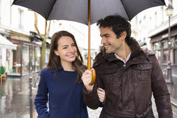 Handsome couple under the rain on street © ldprod