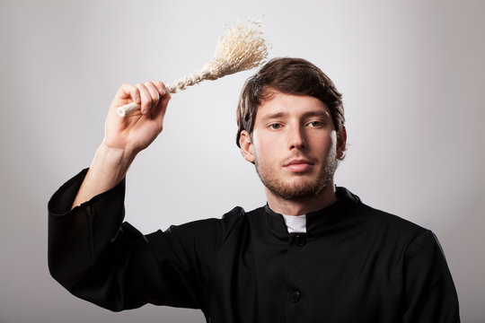 Priest with sprinkler