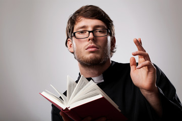 Priest with Holy Bible