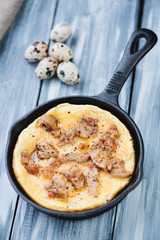 Quail eggs omelette with fried pork, vertical shot