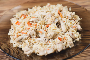 Pilaf with chicken in a glass plate, close-up