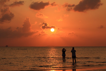 Lover on beach sunset with golden light effect